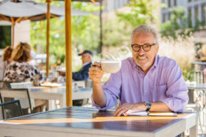 Dr. Will Miller smiling and drinking coffee.